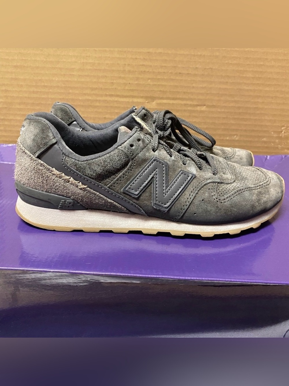 New Balance women’s Dark Gray Suede 696 Sneakers